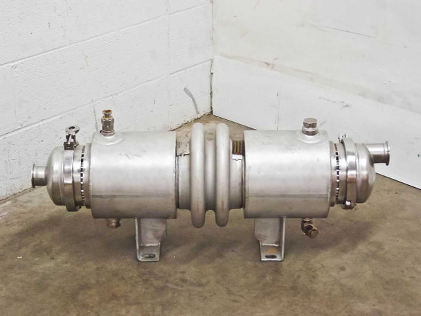 Adsco SXXNCX00 stainless shell and tube condenser — right-side three-quarter view showing end nozzle connections, tri-clamp closures, and center bellows section