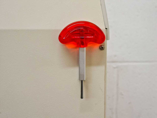 Tomy MRX-152 rear panel close-up – red rotor removal key/tool mounted on side of unit