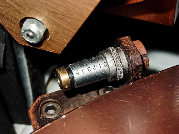 Close-up detail of Villa Precision GS-210 scribing head fine adjustment mechanism showing micrometer-style scale (0–5), mounting hardware, and visible surface rust on hardware components