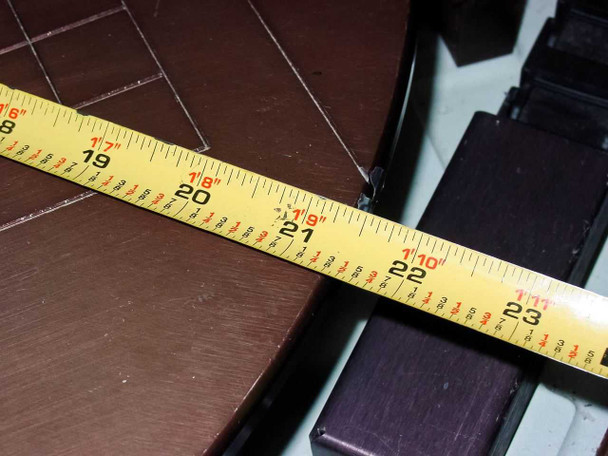 Tape measure across Villa Precision GS-210 vacuum chuck stage showing approximately 20-inch diameter measurement of the circular stage