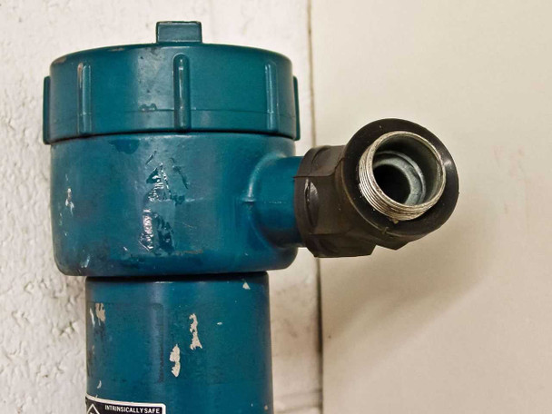 MTS Temposonics LT107501000 transmitter head close-up showing threaded conduit fitting and housing detail with paint chips