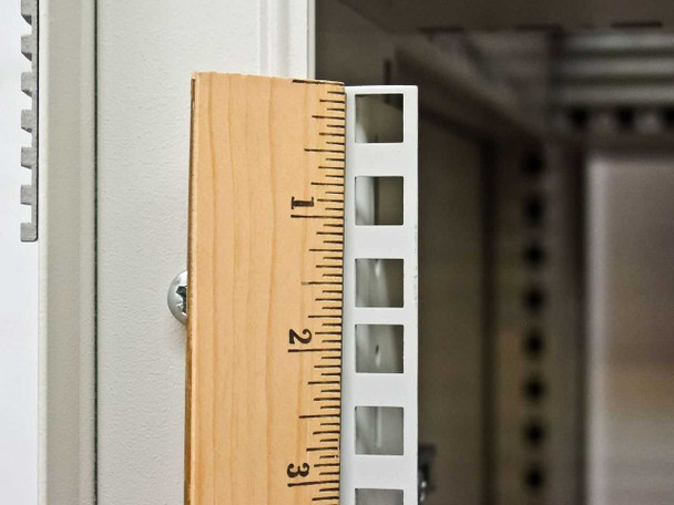 Close-up of Rittal VRiS383151 rack rail with ruler showing approximately 1U spacing between mounting holes