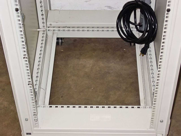 Lower interior of Rittal VRiS383151 rackmount cabinet showing base, caster, and coiled AC power cord