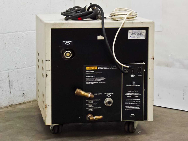 Varian 323-0012 Cryocompressor 2.1 — rear panel showing helium supply fitting, water supply and return connections, helium return port, power spec label, and caution placard