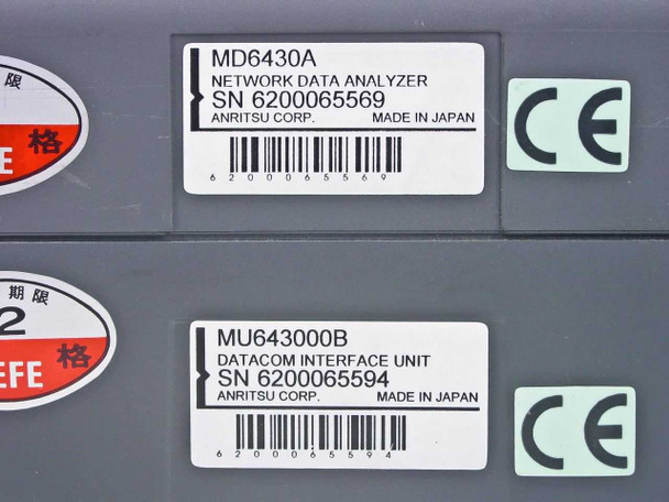 Anritsu MD6430A and MU643000B serial number labels — MD6430A SN 6200065569, MU643000B Datacom Interface Unit SN 6200065594, both made in Japan by Anritsu Corp., CE marked