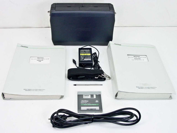 Anritsu MD6430A Network Data Analyzer full kit — carrying case, two Japanese manuals, AC adapter, shoulder strap, stylus pen, Remote Sample Program floppy disk, and power cord laid out on white surface
