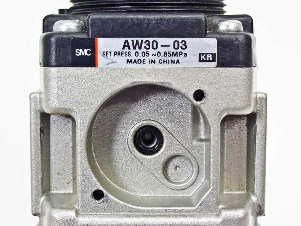 SMC AW30-03 top label closeup showing model number, set pressure 0.05–0.85 MPa, KR suffix, and Made in China marking