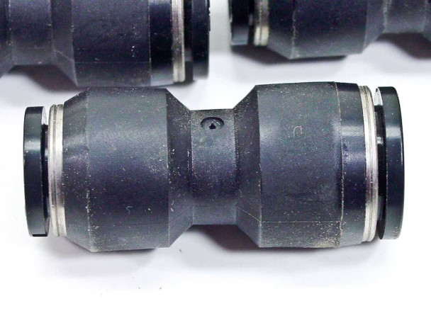 Black SMC straight union push-to-connect fitting — close-up showing both ends and center body