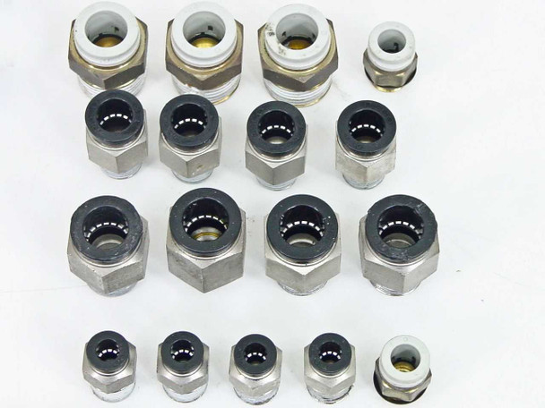 SMC straight push-in connectors close-up — three rows showing large and small straight fittings with metal hexagonal bodies and push-in collets