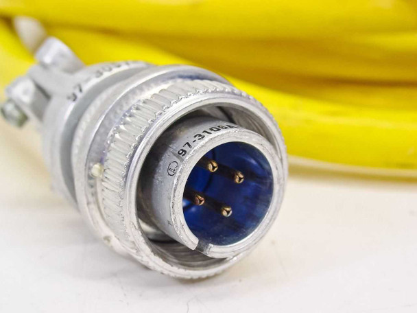 Close-up of male end MilSpec connector on yellow interconnect cable — 4-pin male with blue insert, marked 97-3-106