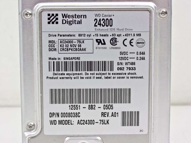 Western Digital WD Caviar 24300 drive label close-up showing model AC24300-75LK, drive parameters, voltage ratings, and Singapore manufacture