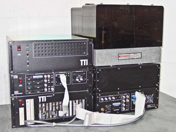 Full TTI T9000 system left rack stack — rackmount TTI power/control units with visible TTI branding, floppy drive and expansion card backplane in Control PC, ribbon cables; Mojave-labeled enclosure and main spinstand enclosure to the right