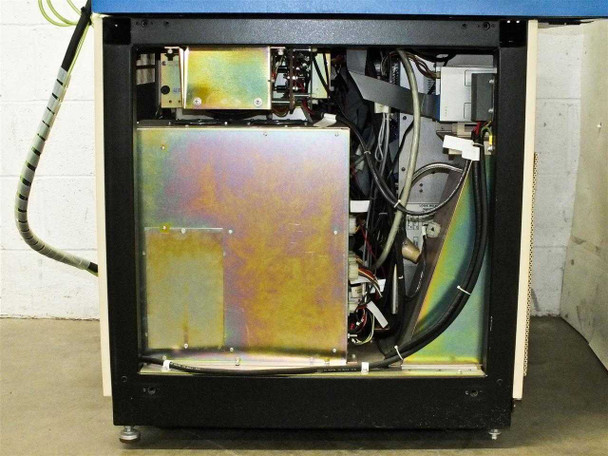 Interior lower cabinet view showing wiring harnesses, chassis, and iridescent metal panel