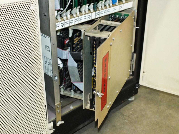 Card cage door open showing multiple populated PCBs and a red warning label