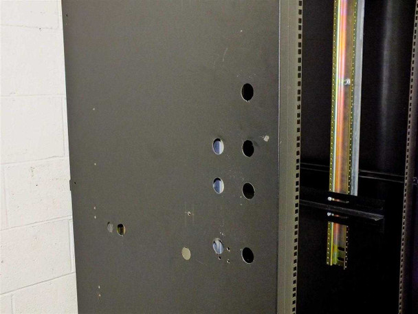 Side panel detail of 37U rackmount cabinet showing multiple pre-punched cable entry knockouts and gold vertical rail