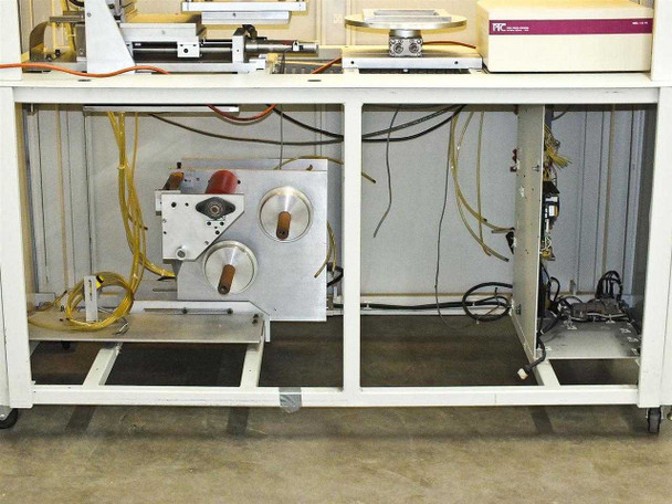 Rear undercarriage view of BF-200 with cabinet doors open showing tape reel drive assembly and wiring harnesses