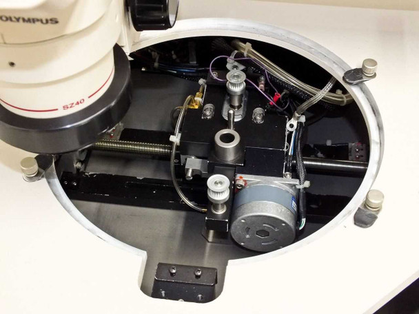 Circular wafer chuck stage interior showing motorized X/Y positioning mechanism, stepper motors, and drive components