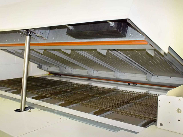 Vitronics ISO5006 reflow oven — interior view showing upper heating zone panels, orange heating elements, and wire mesh conveyor belt