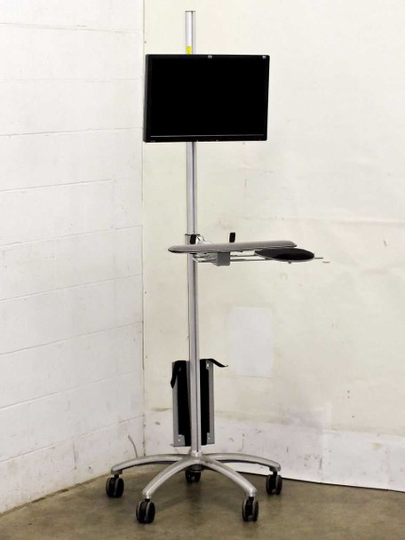 Global Industrial 607300 mobile LCD workstation cart — full front view with HP L2045w 20in monitor mounted at top, keyboard/mouse tray at mid-height, and CPU holder at base on five-caster aluminum base