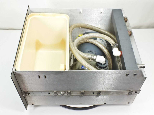 Interior top-down view of rackmount water cooler showing plastic reservoir tray and Magnetek motor with braided hose