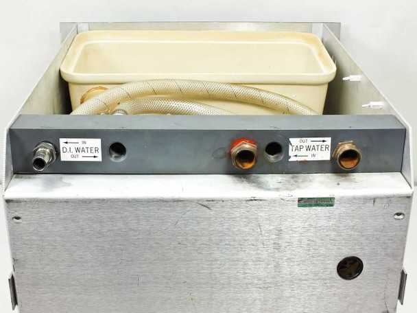 Rear panel of rackmount water cooler showing labeled DI Water Out and Tap Water Out ports with brass fittings