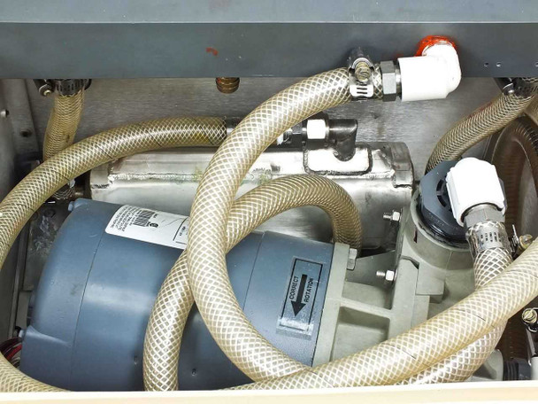 Interior close-up of pump motor assembly, heat exchanger, and braided hose connections inside cooler chassis