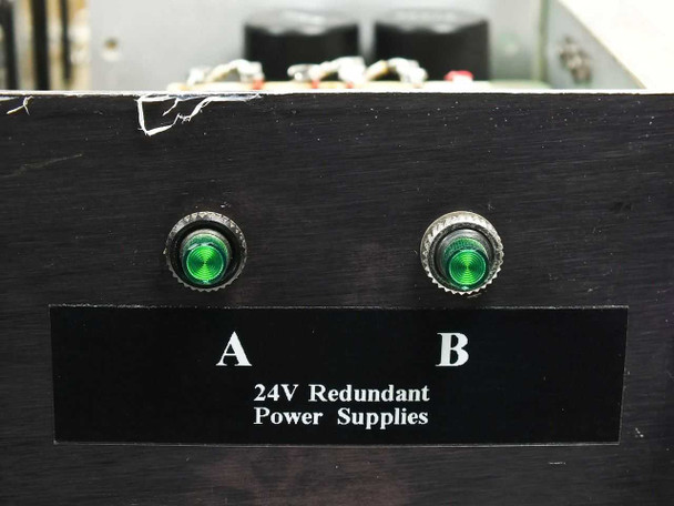 Close-up of front panel right side showing dual green LED power indicators labeled A and B with '24V Redundant Power Supplies' placard below