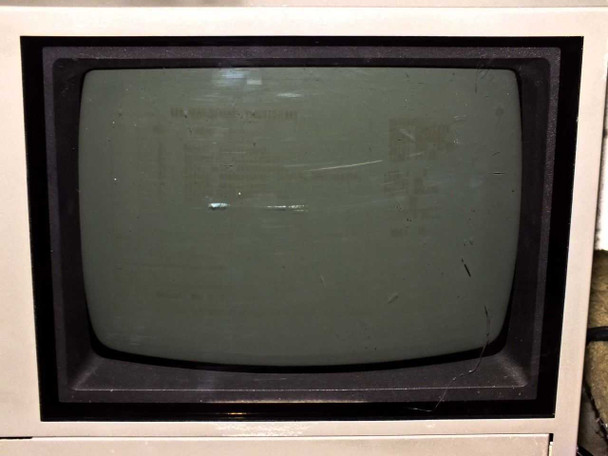 Seiko SFT7000 CRT monitor screen — powered off, showing surface wear and light scratches