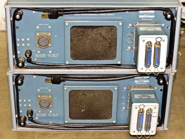 Rear panel view of two stacked Tektronix 1140A Programmable Power Supply units — showing large military circular output connectors, BNC ports, Centronics interface connectors, cooling vents, and attached Program Unit modules