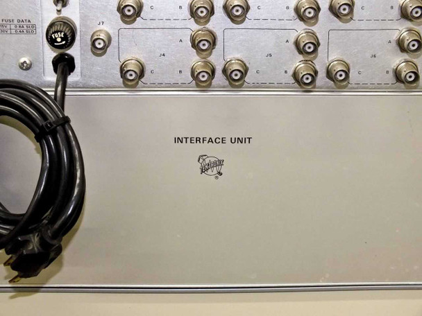 Close-up of Station Control Interface Unit front panel — shows 'INTERFACE UNIT' label with Tektronix logo and array of BNC connectors across the top portion
