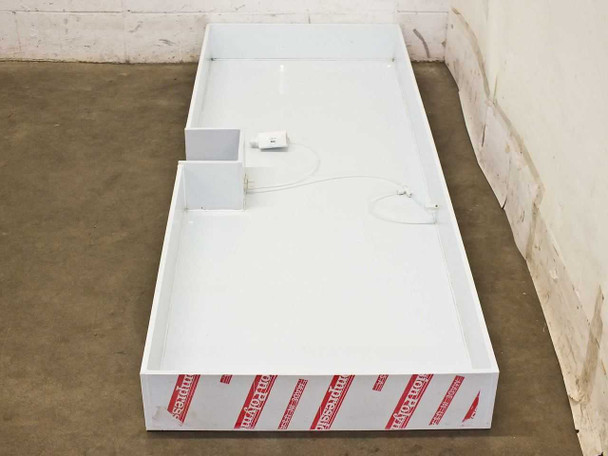 Compression Polymers 82x51x12 drip tray with pneumatic valve and tubing installed – overhead view