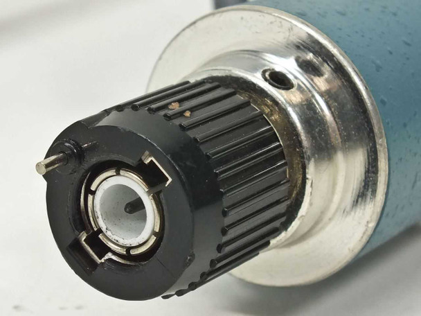 Macro close-up of Tektronix P6009 scope-end connector showing center pin, locking ring, and black compensation dial