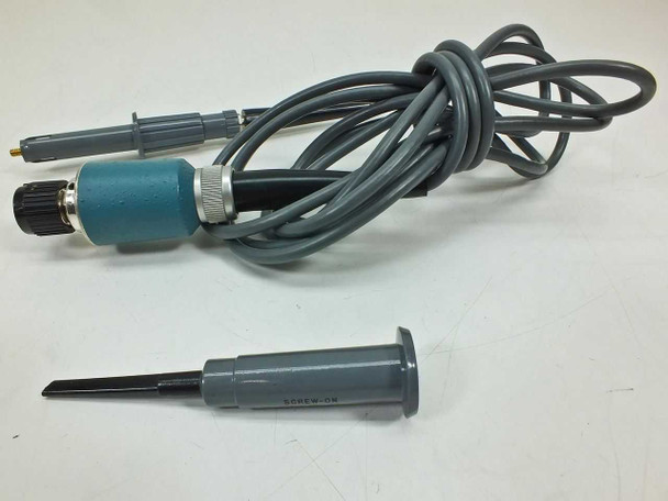 Tektronix P6009 100X passive probe full view with coiled cable, teal handle, and 013-0071-00 screw-on tip shown separately