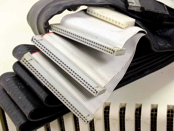 Multiple gray flat ribbon cable connectors and black emulation hose cables stacked on top of the III514B chassis
