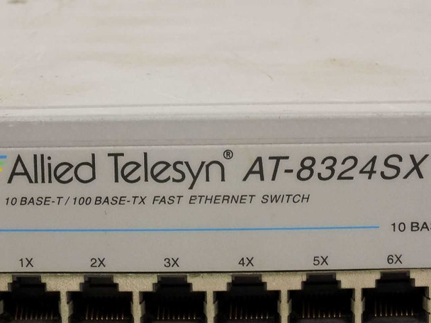 Allied Telesyn AT-8324SX front left close-up showing brand logo and 10 BASE-T / 100 BASE-TX Fast Ethernet Switch designation with ports 1X–6X and 13X–18X