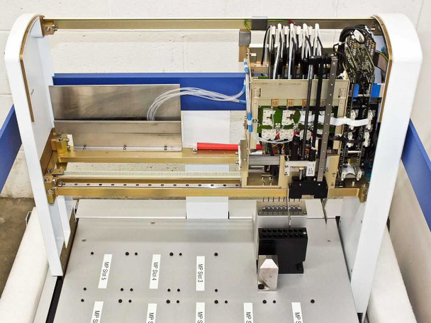 Interior view of BioRobot 8000 with front panel removed showing robotic XYZ gantry, linear rail assembly, control electronics, and wiring harness above the deck