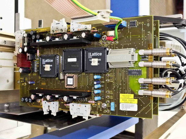 BioRobot 8000 main controller PCB showing two large Lattice FPGA chips, electrolytic capacitors, connectors, and flat ribbon cables