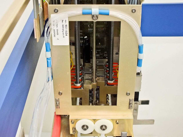 Side view of BioRobot 8000 Z-axis pipetting head assembly with spring-loaded probe guides, drive gears at base, and blue tubing retaining clamps