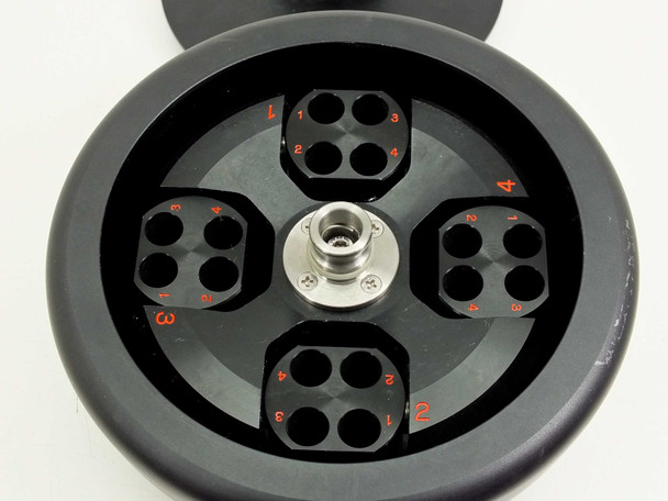 Tomy TMS-4 centrifuge rotor interior showing 4 swing buckets each with 4 tube positions numbered in red, stainless hub