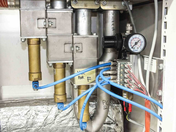 Lanco LTX08 pneumatic manifold closeup — VIMMA-labeled brass valves, pressure gauge, blue pneumatic tubing, and wiring terminal blocks