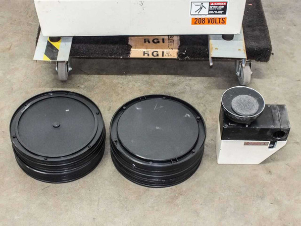 Sibert MBF-150 accessories laid out – two stacks of black disc platters/chucks and one sanding/polishing head unit