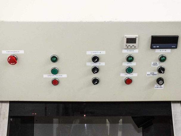 Right-side control panel close-up showing emergency stop, light controls, spin controls, Fuji MD4E timer, and RPM display