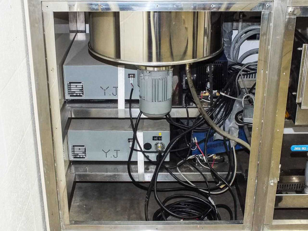 Under-bench cabinet left side showing two YJ-labeled ultrasonic generator/power supply units and drive motor