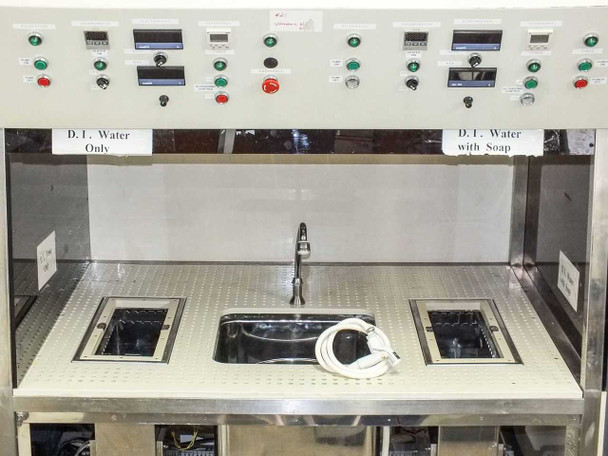 Front view of cleaning workstation bench top showing 'D.I. Water Only' and 'D.I. Water with Soap' zones, center sink, and two flush-mounted ultrasonic bath tanks with control panels above