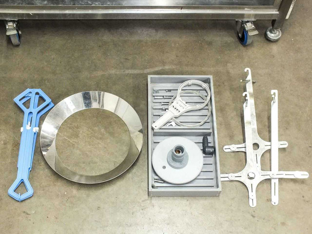 Accessories laid out on floor: blue plastic disc carrier, stainless steel wafer ring, tray with cable/probe, and two white wafer arm fixtures