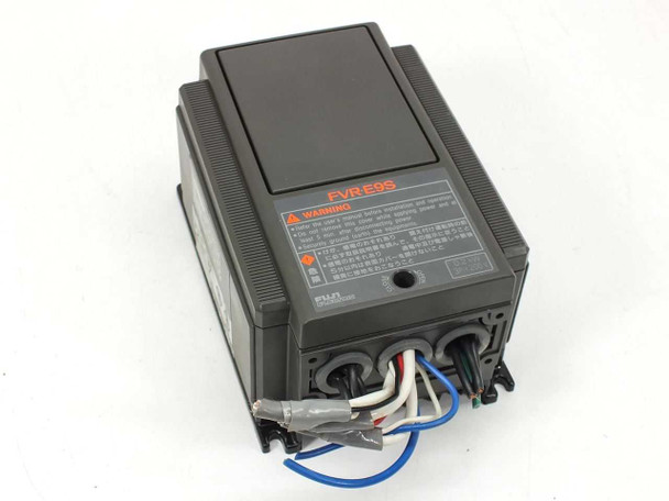 Fuji Electric FVR-E9S VFD inverter — front-top view showing FVR-E9S label and warning placard with wiring leads attached at bottom