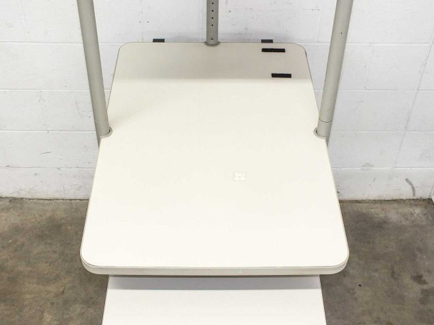 Top-down view of main middle shelf showing rear attachment clips and height adjustment column with cable port slot