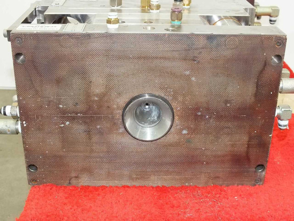 Meike MDMI injection mold – injection/sprue gate side showing circular gate bushing centered on mold face with mounting bolt pattern