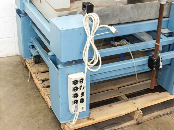 Tripp Lite Isobar IB-8 noise filter and surge suppressor power strip mounted on table frame side rail