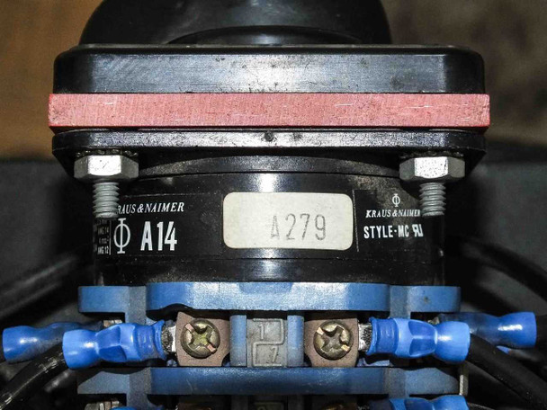 Kraus & Naimer A14 rotary switch detail — nameplate showing A14, Style-MC, UL listed markings, mounted between red brackets above blue terminal block